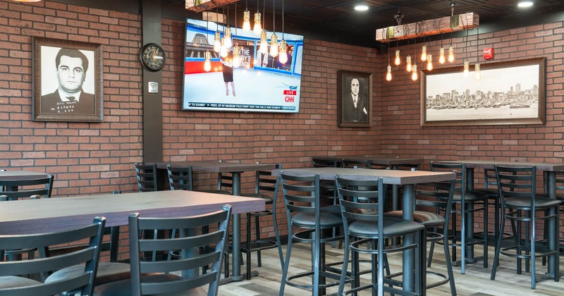 Interior, tall tables, bar stools and TV on the wall