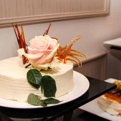 White cake with a rose decoration