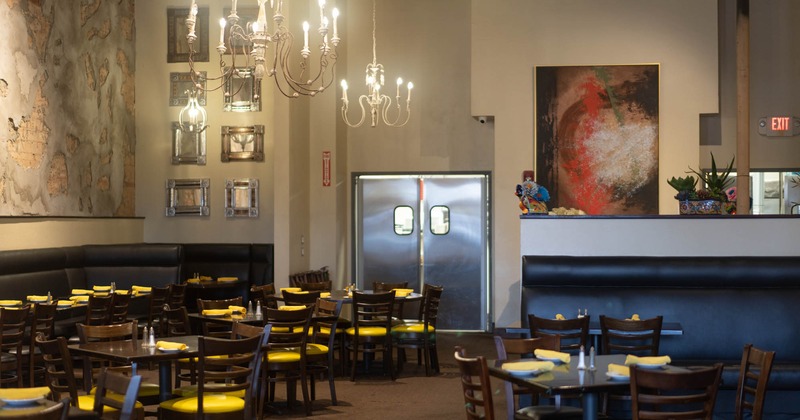 Interior, dining table and seating, chandeliers and wall decoration