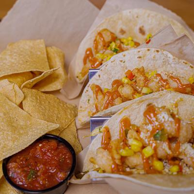 Shrimp Tacos served with tortilla chips and red salsa