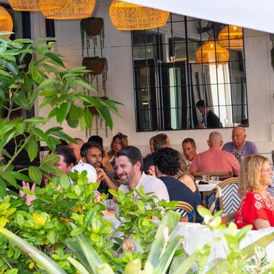 group of people dining at an outdoor patio.