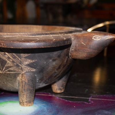 A wooden kava container in the shape of a turtle.