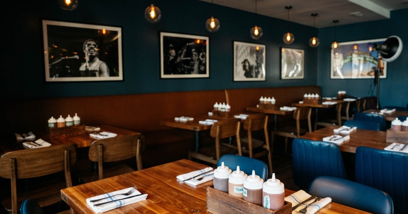 Dining area, tables and seating, wall decorated with framed pictures of musicians
