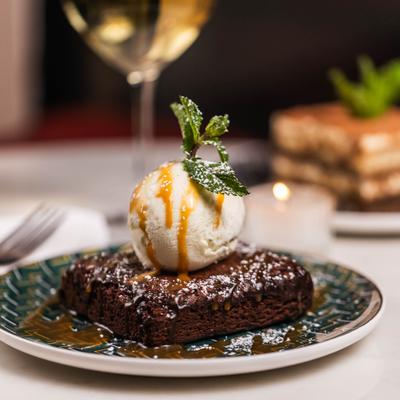 Chocolate brownie topped with vanilla ice cream and caramel sauce.