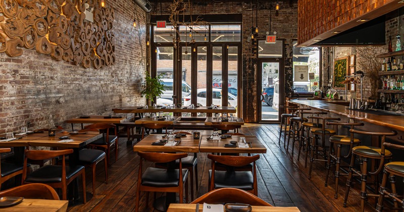 Rustic restaurant interior with brick walls, wooden floors and a bar area