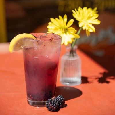 A served beverage and flowers in the background.