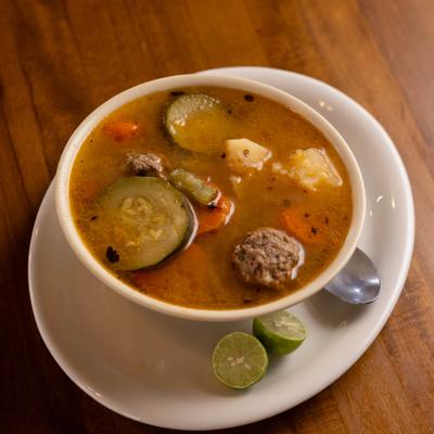 Mexican meatball soup served with lime.