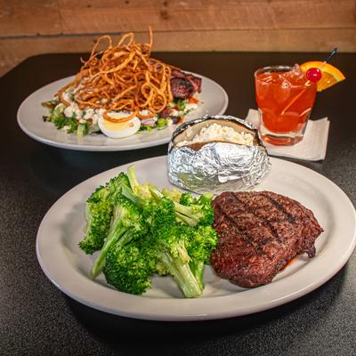 Steak Dinner served alongside Steak Cobb Salad and Old Fashioned cocktail.