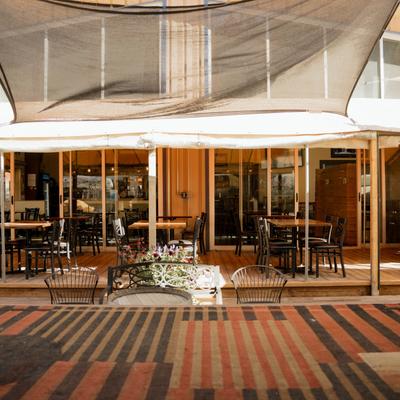 The entrance to the restaurant and tables in front.