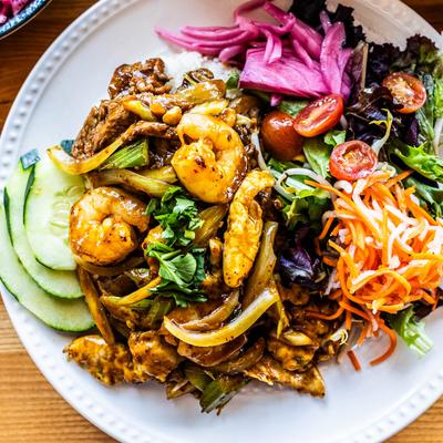 Meat trio fried rice, served on a plate, top view