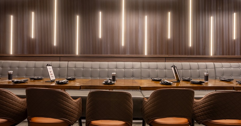 Large dining table with cozy upholstered seats and upholstered chairs