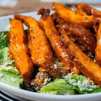 Buffalo Chicken Salad, with lettuce, and grated cheese.