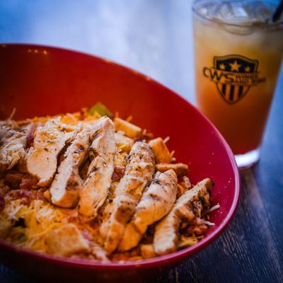 Grilled chicken salad, with lettuce, bacon, cheese, onion, tomatoes, and croutons.