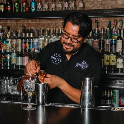 Bartender making a cocktail.