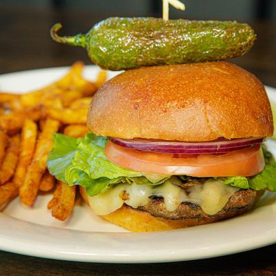 Cheeseburger, with jalapeno, onion, tomato, lettuce, and fries.