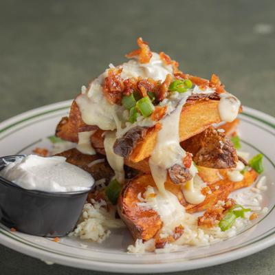 Loaded Potato Wedges served with sour cream on the side