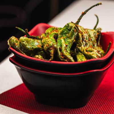 Shishito peppers topped with spices.