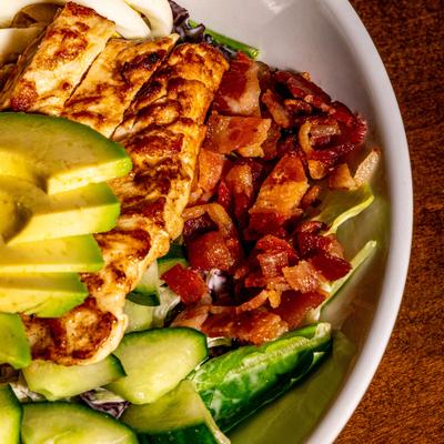 Cobb salad with bacon, cucamber, chicken and avocado, close-up.