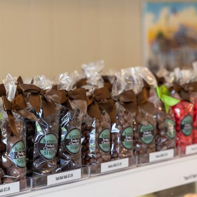Bags of chocolates lined up on a shelf.