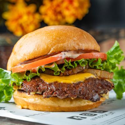 Pineapple Burger with cheese, lettuce and tomato.