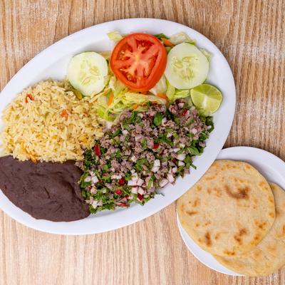 Shredded beef with mixed vegetables, salad, rice, beans and tortillas, topview