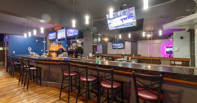 Bar area with barstools and TVs above