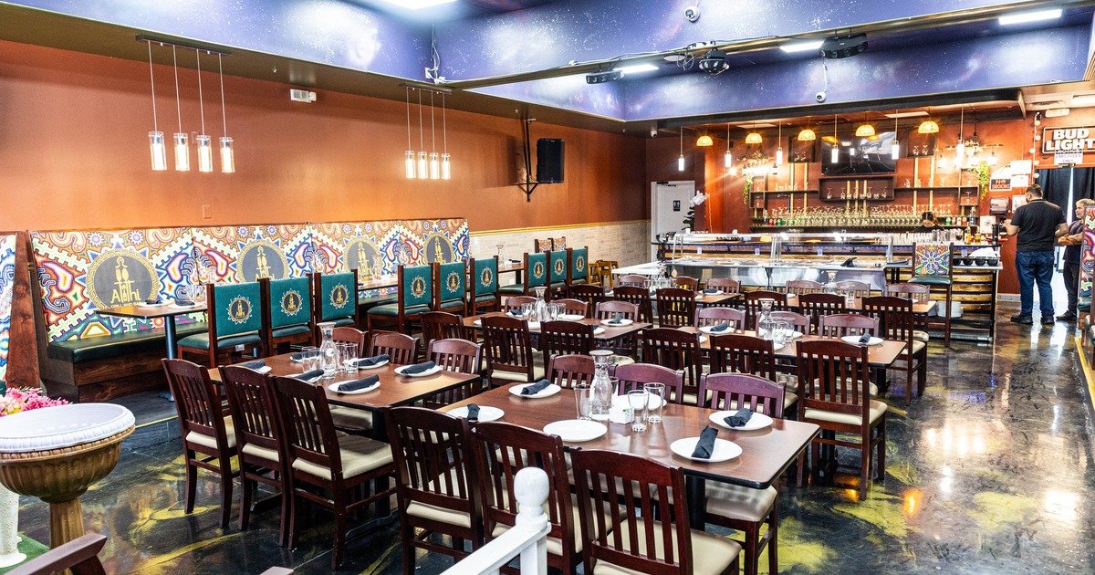 Interior, dining area, wooden tables with chairs for six, long banquette bench with tables