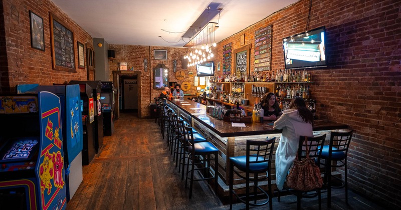 Interior, bar counter area, arcade machines on left