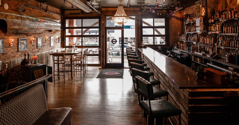 Interior, counter, chairs, upholstered seats, bottles on shelves, windows, glass doors