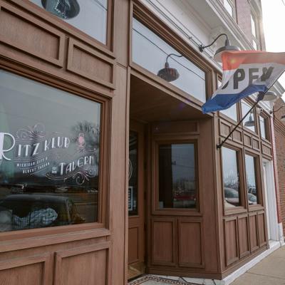 Exterior, storefront with signage on the windows and entrance.