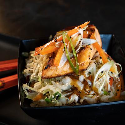 Salmon stir fry with cabbage, onions, peppers, and sesame seeds.