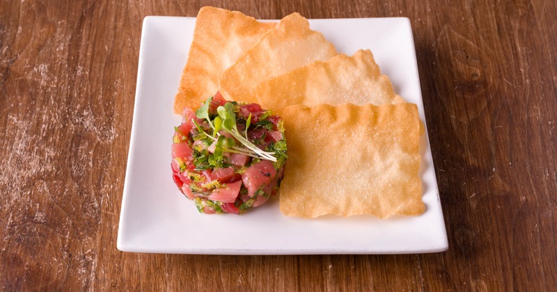 Tuna tartare served with fried wonton chips on the side