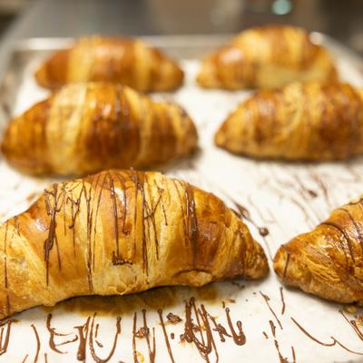 Freshly baked chocolate drizzled croissants.