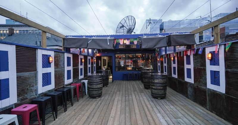 Exterior, patio space with open roof, tables and bar chairs