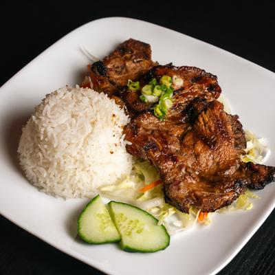 Grilled pork chop, with rice and veggies.