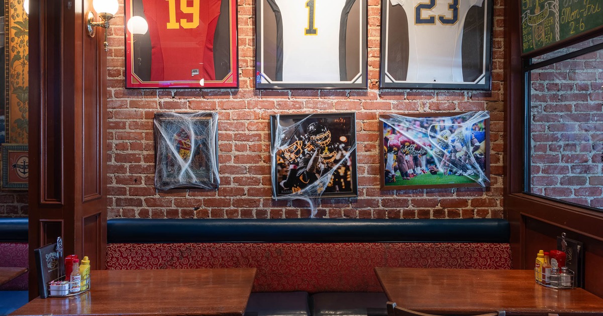 Banquette seating, framed photographs and jerseys