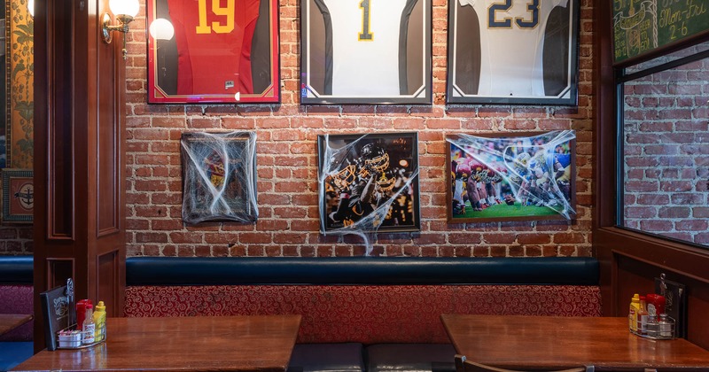 Banquette seating, framed photographs and jerseys