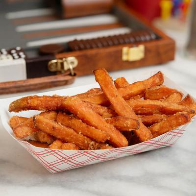 A serving of sweet potato fries seasoned with salt and pepper.