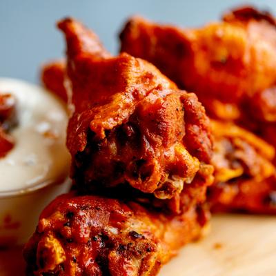 Chicken wings and sauce for dipping, close up.