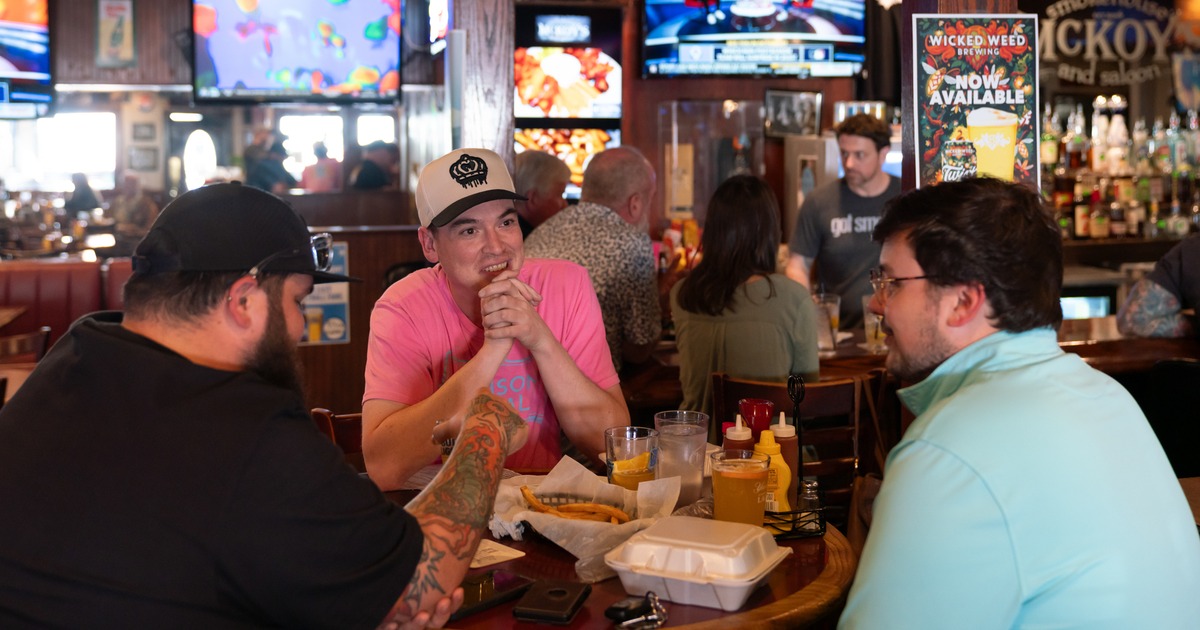 Round bar table, food, guests