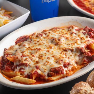 Baked Ziti topped with marinara sauce and melted mozzarella.