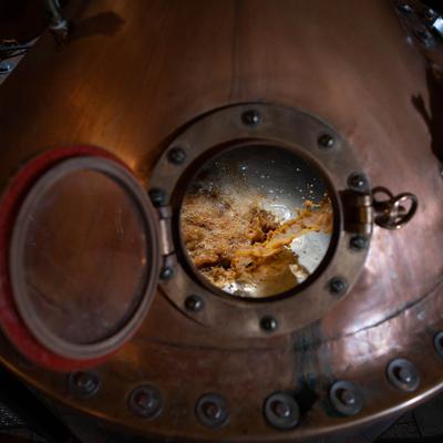 Beer pouring into our handmade copper pot still