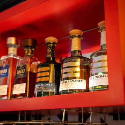 Bottles of tequila lined up on a bar shelf.