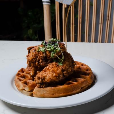 Chicken and waffles with microgreens.
