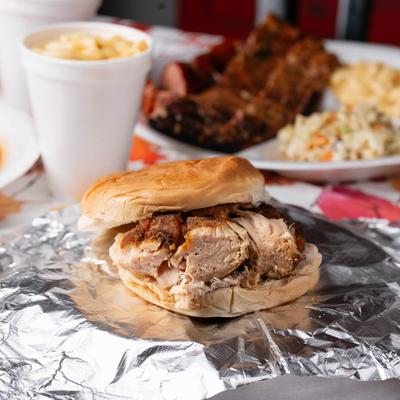 Chicken Breast sandwich served with assorted dishes.