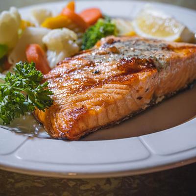 Grilled salmon with herb butter and vegetables