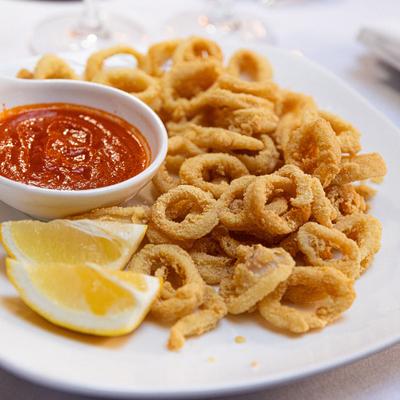 Fried calamari served with lemon wedges and marinara sauce.
