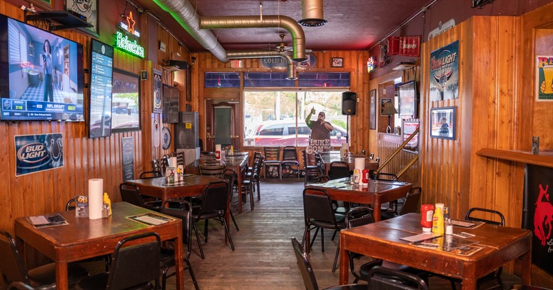 Interior, dining tables ready for guests, TVs