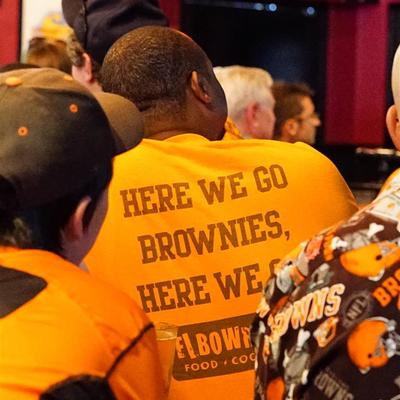 A fan in an orange jersey from the back, here we go brownies