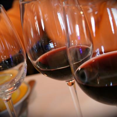 A row of glasses filled with red wine, close up.